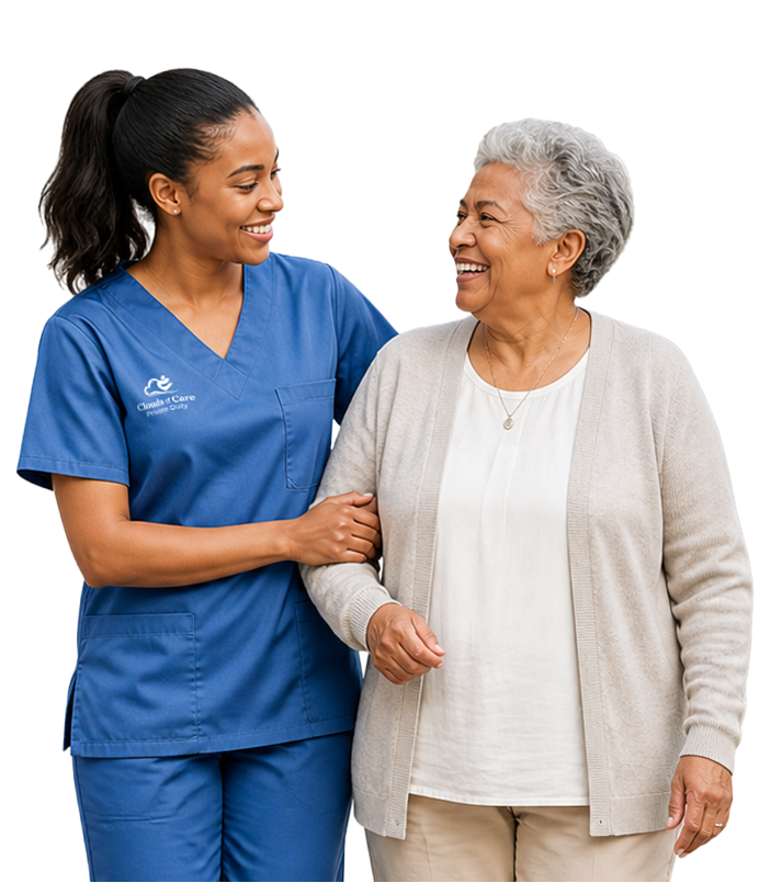 A Clouds of Care caregiver in blue scrubs walks arm-in-arm with an elderly female client, both smiling warmly at each other
